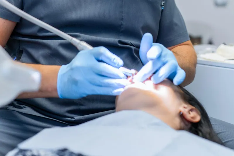 Dental professional treating a patient
