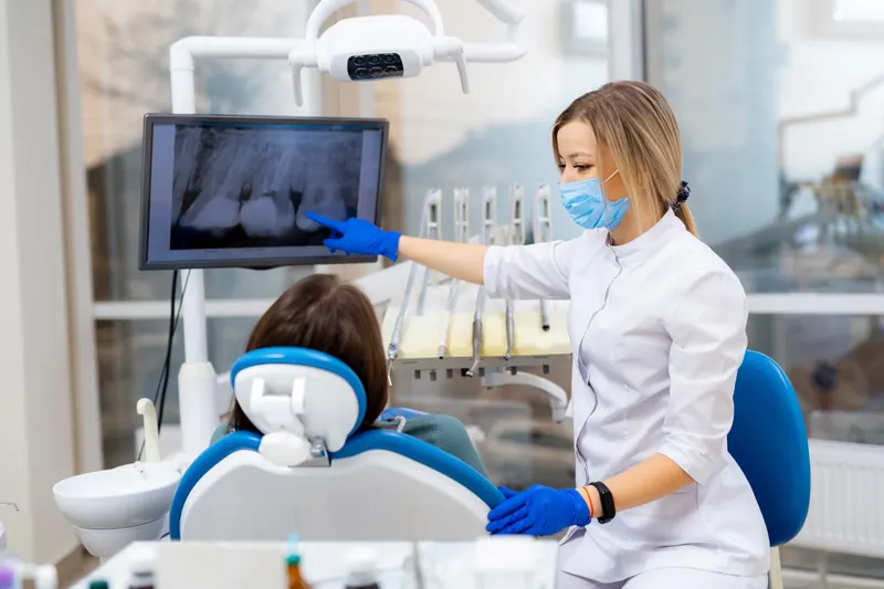 Dentist reviewing dental imaging with a patient